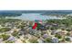 Aerial view featuring the property in a lush, residential neighborhood close to a lake at 715 Hanover Ct, Lakeland, FL 33813
