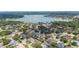 Aerial view highlighting a property near a tranquil lake, showcasing the neighborhood's serene setting at 715 Hanover Ct, Lakeland, FL 33813