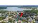 Aerial view showcasing the property's location near a serene lake and surrounded by tree-lined streets at 715 Hanover Ct, Lakeland, FL 33813