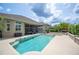 Stunning backyard pool with spa, lush landscaping, and screened lanai providing a luxurious outdoor oasis at 715 Hanover Ct, Lakeland, FL 33813