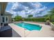 Spacious backyard pool with a surrounding patio, offering a refreshing escape and outdoor living space at 715 Hanover Ct, Lakeland, FL 33813