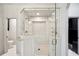 Bathroom featuring white tile, gold hardware, glass shower, and commode area at 715 Hanover Ct, Lakeland, FL 33813
