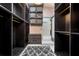 Walk-in closet with open shelves, drawers, carpet, and access to bathroom at 715 Hanover Ct, Lakeland, FL 33813