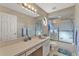 Bathroom with large mirror, a shower-tub combination, and neutral-toned tiles at 7230 Hileman W Dr, Lakeland, FL 33810