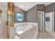 Well-lit bathroom featuring a garden tub, and a separate shower at 7230 Hileman W Dr, Lakeland, FL 33810