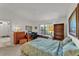 Comfortable bedroom featuring a bed, desk, bookshelf, and a window with natural light at 7230 Hileman W Dr, Lakeland, FL 33810
