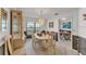 Charming dining room featuring modern chandelier, large window, and classic wood cabinet at 7230 Hileman W Dr, Lakeland, FL 33810