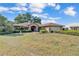 Well-maintained brick home with a manicured lawn and mature landscaping at 7230 Hileman W Dr, Lakeland, FL 33810