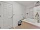 Simple laundry room with utility sink, overhead cabinet, and lots of open space at 7230 Hileman W Dr, Lakeland, FL 33810