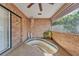 Enclosed patio with an in-ground hot tub, and brick walls at 7230 Hileman W Dr, Lakeland, FL 33810