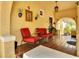 Charming front porch with stucco walls, red seating, and decorative wall hangings at 845 E Edgewood Dr, Lakeland, FL 33803