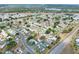 A beautiful aerial view of a neighborhood with mature trees near a major road and lake at 1010 Penguin Pl, Lakeland, FL 33809