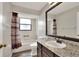 Bathroom with shower-tub combo, granite vanity, and decorative mirror at 1010 Penguin Pl, Lakeland, FL 33809