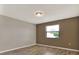 This bedroom features new flooring, neutral paint, and a bright window for natural light at 1010 Penguin Pl, Lakeland, FL 33809