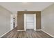 This bedroom boasts new flooring, neutral paint, a closet and access to other rooms at 1010 Penguin Pl, Lakeland, FL 33809