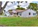 Charming single-story home with a well-maintained lawn, mature trees, and a welcoming exterior at 1010 Penguin Pl, Lakeland, FL 33809