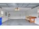 Spacious garage with workbench, door to the outside, and water heater at 1010 Penguin Pl, Lakeland, FL 33809