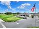View of the golf course with a clubhouse, putting green, and American flag waving in the wind at 1010 Penguin Pl, Lakeland, FL 33809
