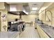 Commercial kitchen with stainless steel appliances, range hood, and multiple sinks at 1010 Penguin Pl, Lakeland, FL 33809