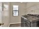The laundry room includes a window for natural light, wire shelving, and modern appliances at 1010 Penguin Pl, Lakeland, FL 33809