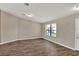 Bright living room with vinyl floors, neutral walls, and large window offering natural light at 1010 Penguin Pl, Lakeland, FL 33809