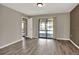 Spacious living room with wood-look flooring and sliding glass doors to the lanai at 1010 Penguin Pl, Lakeland, FL 33809