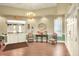 The lobby features a chandelier, tiled floor, and seating with a beautiful floral centerpiece at 1010 Penguin Pl, Lakeland, FL 33809