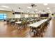 The large meeting room has wood floors, drop ceiling, stage, and many tables and chairs at 1010 Penguin Pl, Lakeland, FL 33809