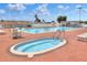 Large community pool and hot tub area with plenty of seating and shade at 1010 Penguin Pl, Lakeland, FL 33809