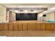A stage with wood floors and cabinets and dark curtains in front of a black backdrop at 1010 Penguin Pl, Lakeland, FL 33809