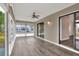 Bright sunroom with new floors, ceiling fan, and lots of natural light at 1010 Penguin Pl, Lakeland, FL 33809