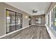 Bright sunroom with new floors, ceiling fan, and lots of natural light at 1010 Penguin Pl, Lakeland, FL 33809