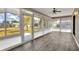Bright sunroom with new floors, ceiling fan, and backyard view at 1010 Penguin Pl, Lakeland, FL 33809