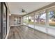 Bright sunroom with new floors, ceiling fan, and lots of natural light at 1010 Penguin Pl, Lakeland, FL 33809