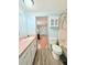 Bright bathroom featuring a pink vanity, modern toilet, and a shower with a neutral tone at 1011 Pine Ridge Dr, Lakeland, FL 33809