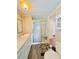 Bright bathroom featuring a seated shower, wood-look floors, updated vanity, and ample natural light at 1011 Pine Ridge Dr, Lakeland, FL 33809