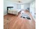 Light and airy bedroom with neutral walls, wood-look floors, a ceiling fan, and a comfy chair at 1011 Pine Ridge Dr, Lakeland, FL 33809