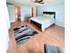 Spacious bedroom with wood-look flooring, ceiling fan, ensuite bathroom, and walk-in closet at 1011 Pine Ridge Dr, Lakeland, FL 33809