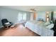 A nicely sized bedroom with an ensuite bath, ceiling fan, comfy chair, and ample lighting at 1011 Pine Ridge Dr, Lakeland, FL 33809