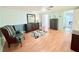 Bedroom with wood-look floors, soft green and blue walls, and updated light fixtures and fan at 1011 Pine Ridge Dr, Lakeland, FL 33809