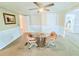 Bright dining area with a glass table, comfy chairs, and a ceiling fan for added comfort at 1011 Pine Ridge Dr, Lakeland, FL 33809