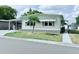 Well-kept single-story home with tidy landscaping, carport, and inviting facade at 1011 Pine Ridge Dr, Lakeland, FL 33809