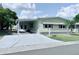 Inviting single-story home with carport, landscaped yard, and charming curb appeal at 1011 Pine Ridge Dr, Lakeland, FL 33809