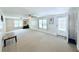 Spacious living room with neutral carpet and plenty of natural light from multiple windows at 1011 Pine Ridge Dr, Lakeland, FL 33809