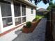 Back porch leading to a landscaped yard with paver walkway at 1014 Lexington St, Lakeland, FL 33801