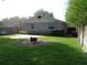 Private backyard with green lawn, stone patio, and mature trees at 1014 Lexington St, Lakeland, FL 33801