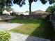 A spacious fenced backyard featuring a stone patio and a lush lawn at 1014 Lexington St, Lakeland, FL 33801