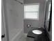 Bright bathroom featuring tiled walls, a modern vanity, and natural light from the window at 1014 Lexington St, Lakeland, FL 33801