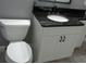 Bathroom featuring a toilet and vanity with a black countertop at 1014 Lexington St, Lakeland, FL 33801
