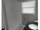 Bathroom featuring a tub, window, and vanity with a black countertop at 1014 Lexington St, Lakeland, FL 33801